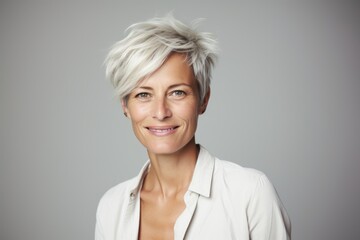 Wall Mural - Mature business woman with short blond hair. Closeup portrait.