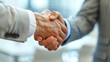 © aekkorn - Professional handshake, close-up, against a sleek.