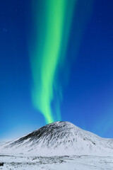 Wall Mural - Aurora borealis on the Lofoten islands, Norway. Northern Lights over the mountains. Scandinavia. Night sky with polar lights. Landscape in the north in winter time.