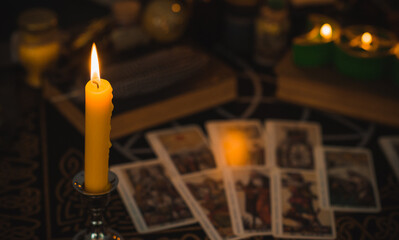 Wall Mural - Altar of modern witch. Candles and oracle stuff on a table. Mental work with energetic. Some rite and fate prediction illustration