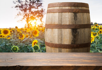 Wall Mural - The empty wooden table top with blur background of sunflower field. Exuberant image. High quality photo