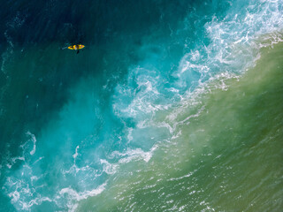 Wall Mural - Two divers in yellow kayaks are rowing in the mouth of the Hadera River in Israel, the color of the water is spectacular and ranges from green to blue