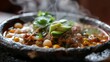 A steaming bowl of pozole stew with tender pork, hominy, and fresh avocado