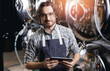 © Parilov - Portrait worker man in aprons use computer tablet on drink brewing factory. Modern technology in craft beer production process of brewery