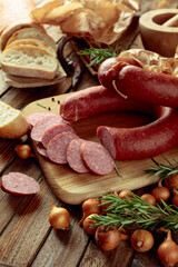 Wall Mural - Smoked sausage with bread and spices on a old wooden table.