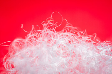 Wall Mural - Extreme macro of polyester stable fiber on red background