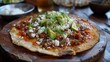 Mexican tlayuda Oaxacan pizza with refried beans, cheese, chorizo, avocado, and salsa on a crispy tortilla