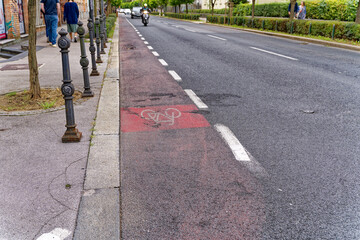 Diminishing view of road with bicycle lane at Slovenian City of Ljubljana on a cloudy summer day. Photo taken August 9th, 2023, Ljubljana, Slovenia.