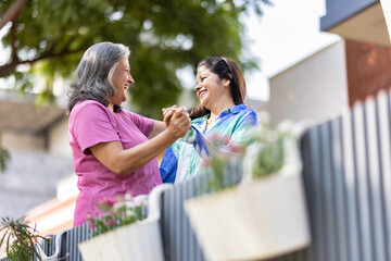 Two cheerful senior female spending leisure time together at outdoor.