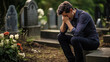 ©  Mohammad Xte - Christian man crying next to a grave with a headstone for a deceased relative in the family