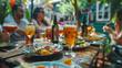 © Александр Марченко - Friends enjoying a meal and drinks together at an outdoor table in a casual dining setting.