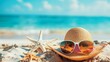 A summer hat with sunglasses on a sandy sea beach is a concept of hot summer and relaxation