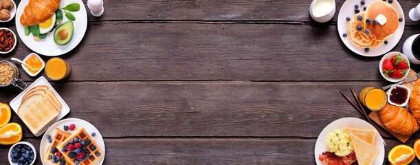 Leinwandbilder - Breakfast or brunch double border on a dark wood banner background. Overhead view. Collection of sweet and savory food items.
