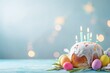 Easter cake, Easter eggs with church candles on the table, soft blue background, copy space/