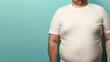 overweight man in tight t-shirt on light blue background