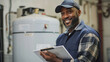 © MP Studio - smiling man wearing a baseball cap and a blue plaid shirt over a blue work uniform, holding a clipboard in an industrial or maintenance setting, possibly a technician or a worker.