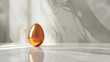 A minimalist composition featuring a single Easter egg with a glossy sheen, placed on a smooth marble surface with subtle reflections