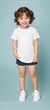 © Portrait Studio - A child model wearing a blank plain t-shirt in a studio shot, perfect for mockups or designing custom shirts as templates