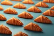 Delicious freshly baked crispy croissants pattern on a turquoise minimalistic background