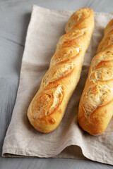 Wall Mural - Homemade French Bread Baguette on a gray background, side view.