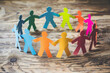 © Aimee - Diversity And Inclusion. Business Employment Leadership. Group of people holding hands together. colorful paper cut out figures of people hand in hand standing around a circle.