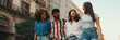 © Andrii Nekrasov - Happy multiethnic young people walk embracing on summer day outdoors, Panorama. Group of friends are talking and laughing merrily while walking along on the street