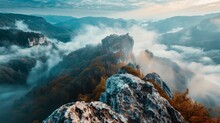 The Rugged Massif Emerges From The Misty Fog, As The Sun Rises Over The Tranquil Highland Wilderness, Creating A Breathtaking Landscape Of Rocky Cliffs And Towering Trees