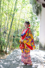 沖縄県那覇市の中国庭園で琉装を着た２０代の若い日本人女性 A young Japanese woman in her 20s wearing Ryuso in a Chinese garden in Naha City, Okinawa Prefecture