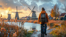 Dutch Windmill In The Country With A Man On A Bicycle