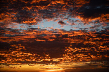 Wall Mural - fiery orange sunset sky in background.