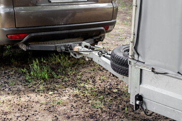 Tow hitch on a car. Trailer drawbar with spare wheel.