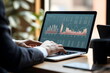 © dobok - A man doing finance and analyzing on a laptop