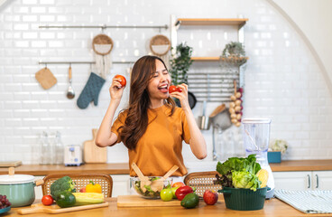 Wall Mural - Portrait of beauty health asian woman having fun hold tomato cooking, vegan food healthy eat, fresh vegetable, Lycopene, vitamins, skincare, vegetarian in kitchen.Diet.Fitness, healthy food