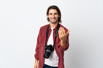 Young photographer man isolated on white background inviting to come with hand. Happy that you came