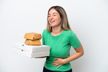 Wall Mural - Young Rumanian woman holding fast-food isolated on white background smiling a lot