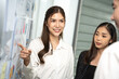 © Bavorndej - Asian businesswoman presenting business strategy to team. They argue about marketing plans together in the office. business idea concept.