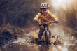 A child is having fun whilst riding the mountainbike through mud on a rainy bad weather day.