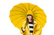 © luismolinero - Little girl with rainproof coat and umbrella over isolated chroma key background posing with arms at hip and smiling