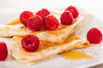 Wall Mural - Delicious pancakes with fresh raspberries and honey