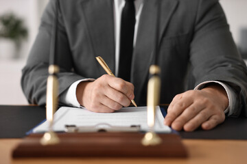 Wall Mural - Notary writing notes at wooden table in office, closeup