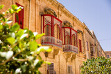 Fototapeta Uliczki - Balconies with worked structure in the center of Mdina (Malta)