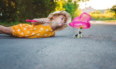 Wall Mural - A child catches a butterfly in nature. selective focus.