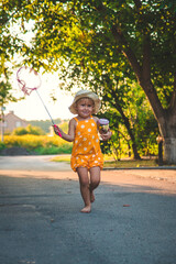 Wall Mural - A child catches a butterfly in nature. selective focus.