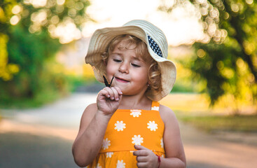 Wall Mural - A child catches a butterfly in nature. selective focus.