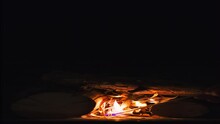 A Man Lights A Fire In A Fireplace, Vertical Video, Late Evening, Natural Light From A Fire, 4k Video, Background Or Screensaver Idea About Home Comfort, Static Camera Footage