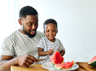 Wall Mural - child family kitchen food boy son father watermelon fruit slice summer organic meal fun preparing healthy diet eating home black