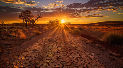 cracked earth road at sunset,