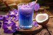 © GreenMOM - An exotic blue coconut cocktail decorated with flowers, offering a taste of the tropics.