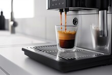 Espresso pouring from a modern machine into a clear glass, highlighting cafe culture
