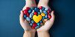 World autism awareness day Children hands in heart with multicolor stones